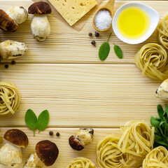 Fototapeta na wymiar Frame of ingredients for cooking pasta. Fettuccine with porcini mushrooms, cheese and sage leaves on a wooden background
