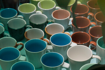 Various colors of ceramic coffee mugs a pattern