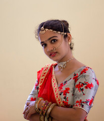 A beautiful young Hindu girl with gold ornaments and red lipstick on her attractive soft lips