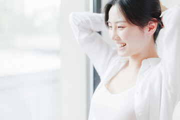 Beautiful young women sitting by the window of Asia

