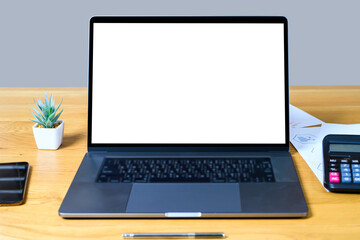 Blank screen laptop computer on wood table with clipping path. business concept. Mockup with copy space.