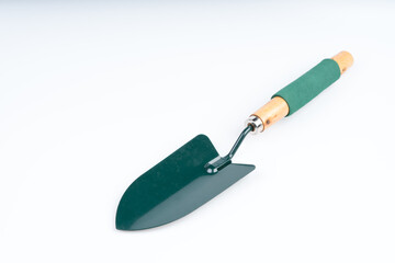 Green garden shovel with wooden handle