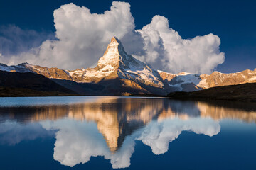 Sunrise on the Stellisee lake. Reflection of Matterhorn peak in the watter surface. Beautiful...