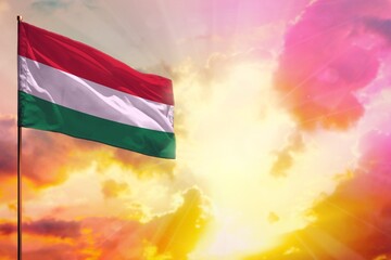 Fluttering Hungary flag in top left corner mockup with the space for your text on beautiful colorful sunset or sunrise background.