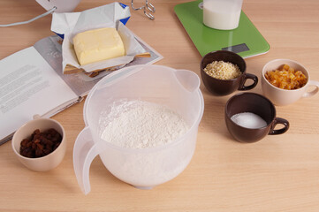 home baking ingredients for traditional german stollen cake recipe - a fruit loaf or bread - on kitchen table