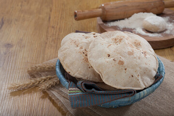 Indian bread (Roti) on a wooden base along with the props.