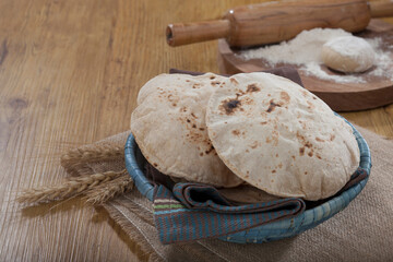 Indian bread (Roti) on a wooden base along with the props.
