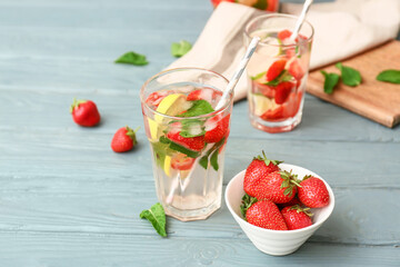 Glass of tasty strawberry mojito on table