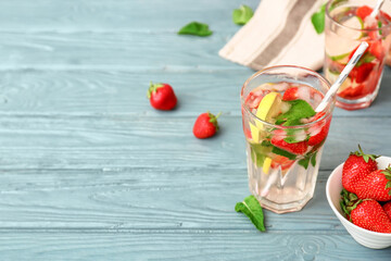 Glass of tasty strawberry mojito on table