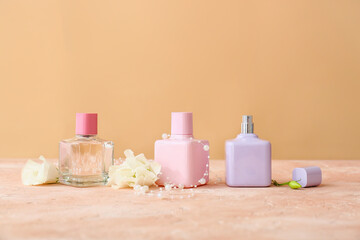 Fototapeta na wymiar Bottles of perfume on color background
