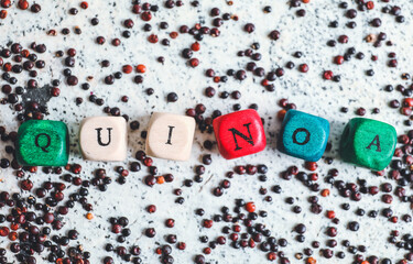 Cubes with word QUINOA on light background