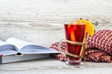 Mulled wine Hot christmas drink with spices on wooden background. Orange slice, cinnamon sticks,...