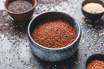 Bowl with healthy quinoa on dark background