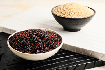 Bowls with healthy quinoa on table