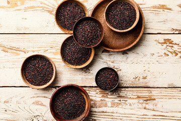 Bowls with healthy quinoa on table