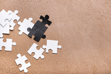 Different puzzle pieces on color background. Racism concept