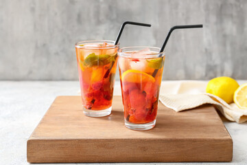 Glasses of tasty strawberry cocktail mojito on table