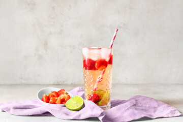 Glass of tasty strawberry cocktail mojito on grey background