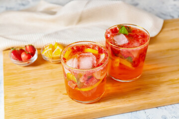 Glasses of tasty strawberry cocktail mojito on table