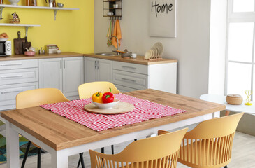 Dining table in interior of modern kitchen