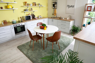 Dining table in interior of modern kitchen