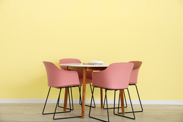 Dining table near color wall
