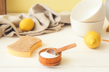 Bowl with soda and sponge on table in kitchen. Ecology concept