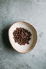 Fresh Coffee Beans on grey concrete background