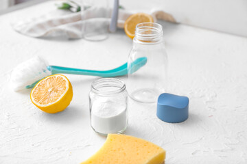 Eco containers for food and drinks with cleaning supplies on white background