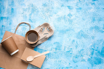Paper bag with cups for coffee and box on color background. Ecology concept