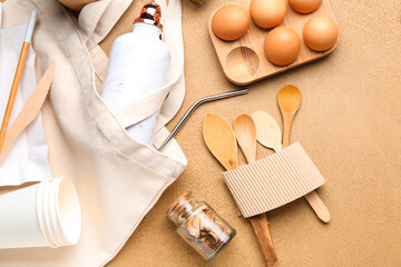 Bag with supplies and food on color background