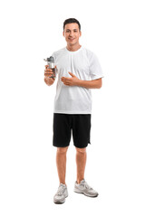 Sporty young man with bottle of water on white background