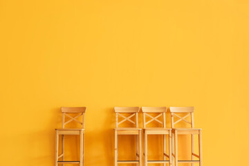 Wooden chairs near color wall