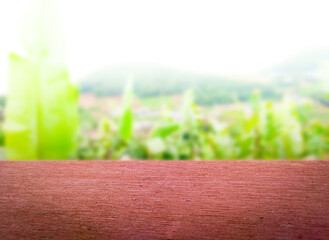 Empty wooden with fresh green nature blurred background. Template for advertising, food, beverage,...