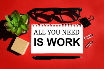 ALL YOU NEED WORK, text on white paper on red background. near the text cube, glasses, plant