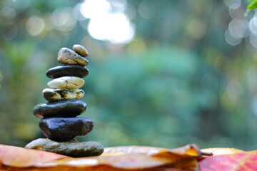zen stones in the garden with green bokeh