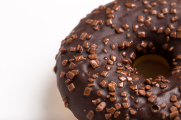 Chocolate donut on a white background close-up.