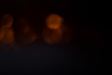Black background with orange bokeh dots