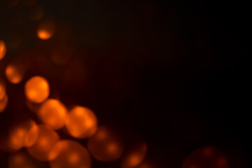 Black background with orange bokeh dots
