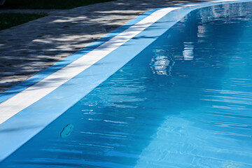 The surface of the water in the blue swimming pool.