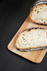 Traditional French country bread slices on a cutting board