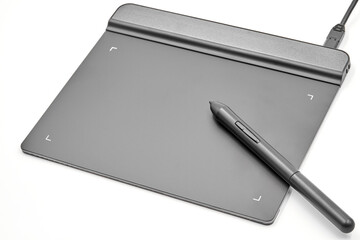 Graphic tablet and pen on white background