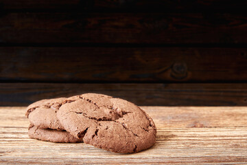 Stacked cookies on wooden table and dark background