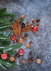 Christmas and New Year holiday background. cones, nuts, cinnamon, fir tree on gray table. winter festive cozy concept.