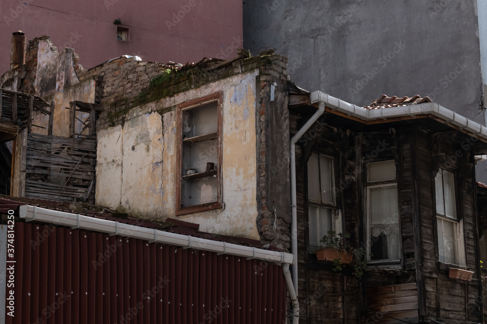 Wall mural decrepit old building in the midst of urban Istanbul