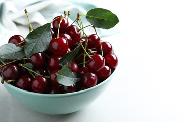 Sweet juicy cherries on light table, closeup. Space for text