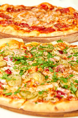 Fresh pizza with bacon, pickles and cheese on a light background. Close-up, selective focus