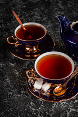 Vintage tea pair with teapot on a black background