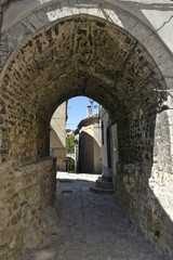 Fototapeta na wymiar A narrow street among the old houses of Riccia, a medieval village in the Molise region.