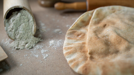Kuboos or khubz - Arabic bread on a brown table in the kitchen